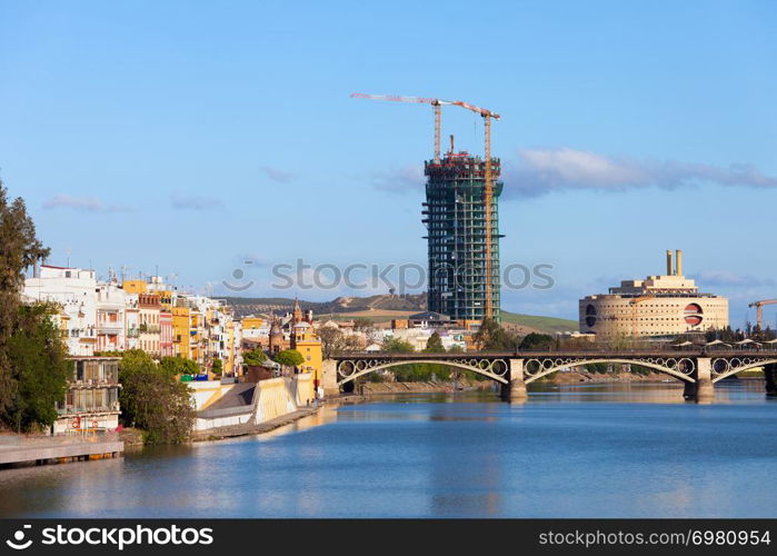 Traditional houses of the Triana District, Guadalquivir river and Isabel II Bridge in the city of Seville, Andalusia, Spain.