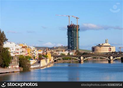 Traditional houses of the Triana District, Guadalquivir river and Isabel II Bridge in the city of Seville, Andalusia, Spain.