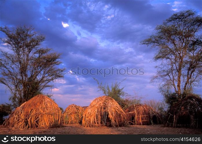 Traditional Huts in Mursi Village in Face of Oncoming Storm