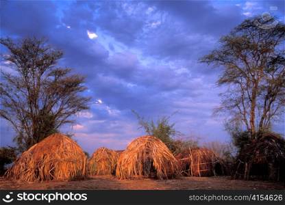 Traditional Huts in Mursi Village in Face of Oncoming Storm