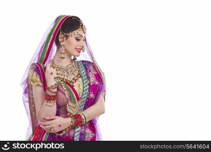 Traditional Indian bride smiling over white background