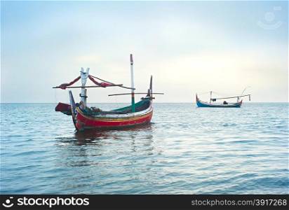 Traditional indonesian fishing boats in the ocean, Jawa island, Indonesia