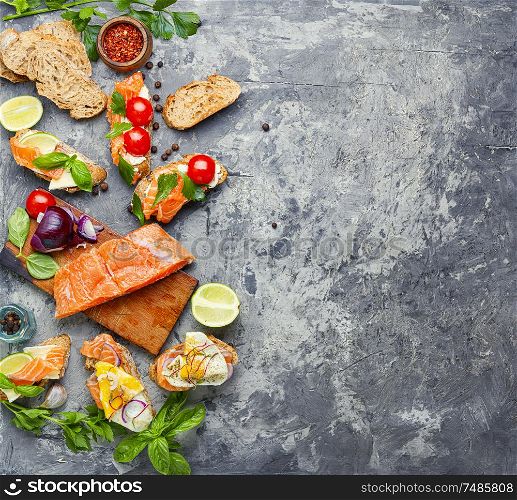 Traditional italian bruschetta.Open sandwich with salmon and ingredients. Assorted bruschetta with fish