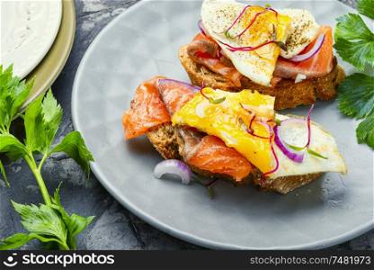 Traditional italian bruschetta.Open sandwich with salmon and vegetables. Open sandwich with fish
