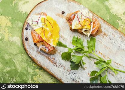 Traditional italian bruschetta.Open sandwich with salmon and vegetables. Open sandwich with salmon