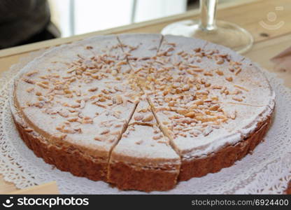 Traditional Italian Cream Cake with Powdered Sugar and Pine Nut