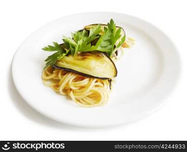 Traditional Italian cuisine. Close-up of spaghetti roll with aubergine, fresh tomatos and parsley. On white background.