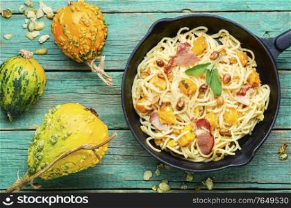 Traditional italian dish spaghetti carbonara with pumpkin and bacon.Pasta carbonara.Pasta with baked pumpkin. Pasta with pumpkin and bacon