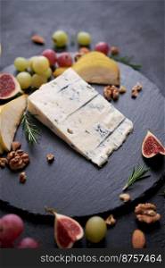 Traditional Italian Gorgonzola cheese on stone seving board.. Traditional Italian Gorgonzola cheese on stone seving board