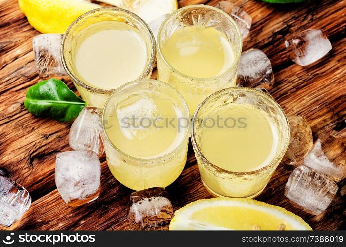 Traditional italian lemon liqueur limoncello and fresh lemon.Summer drink. Italian limoncello with fresh lemons
