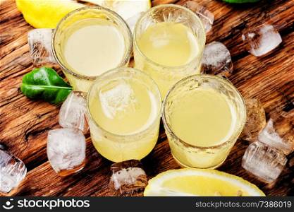 Traditional italian lemon liqueur limoncello and fresh lemon.Summer drink. Italian limoncello with fresh lemons