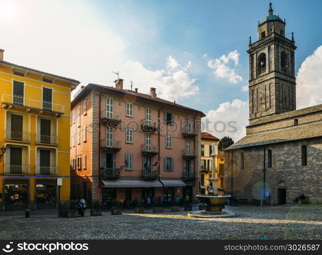 Traditional Italian piazza with a public water fountain outside the Basilica of San Giacomo fin Bellagio, Lake Como, Italy.. Traditional Italian piazza with a public water fountain outside the Basilica of San Giacomo fin Bellagio, Lake Como, Italy