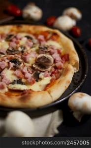 Traditional italian pizza with ham and mushrooms served on plate.. Traditional italian pizza with ham and mushrooms
