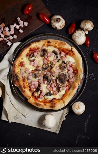 Traditional italian pizza with ham and mushrooms served on plate.. Traditional italian pizza with ham and mushrooms