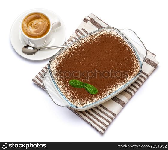 Traditional Italian Tiramisu dessert in glass baking dish and cup of fresh espresso coffee isolated on white background with clipping path embedded. Traditional Italian Tiramisu dessert in glass baking dish and cup of fresh espresso coffee isolated on white background with clipping path