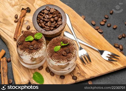 Traditional Italian Tiramisu dessert in glass baking dish on stone serving board isolated on white background with clipping path embedded. Traditional Italian Tiramisu dessert in glass baking dish on stone serving board isolated on white background with clipping path