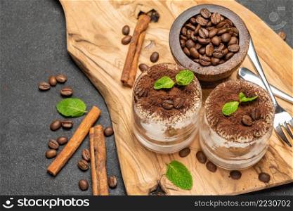 Traditional Italian Tiramisu dessert in glass baking dish on stone serving board isolated on white background with clipping path embedded. Traditional Italian Tiramisu dessert in glass baking dish on stone serving board isolated on white background with clipping path