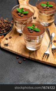 Traditional Italian Tiramisu dessert in glass baking dish, portion on plate and cup of coffee isolatet on white background.. Traditional Italian Tiramisu dessert in glass baking dish, portion on plate and cup of coffee isolatet on white background