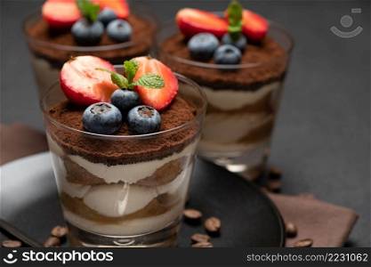 Traditional Italian Tiramisu dessert square portion on ceramic plate and cup of fresh espresso coffee isolated on white background with clipping path embedded. Traditional Italian Tiramisu dessert square portion on ceramic plate and cup of fresh espresso coffee isolated on white background with clipping path