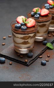 Traditional Italian Tiramisu dessert square portion on ceramic plate, coffee mill grinder and savoiardi cookies a isolated on white background with clipping path embedded. Traditional Italian Tiramisu dessert square portion on ceramic plate, coffee mill grinder and savoiardi cookies a isolated on white background with clipping path