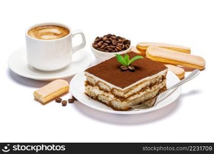 Traditional Italian Tiramisu dessert square portion on ceramic plate, savoiardi cookies and cup of fresh espresso coffee isolated on white background with clipping path embedded. Traditional Italian Tiramisu dessert square portion on ceramic plate, savoiardi cookies and cup of fresh espresso coffee isolated on white background with clipping path