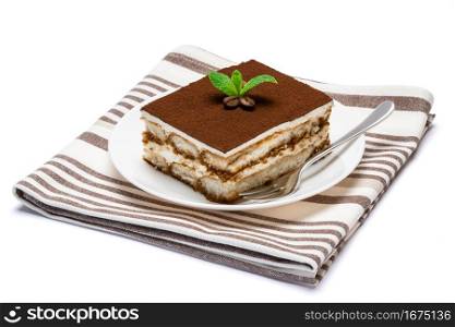 Traditional Italian Tiramisu square dessert portion on ceramic plate isolated on white background with clipping path embedded. Traditional Italian Tiramisu square dessert portion on ceramic plate isolated on white background with clipping path