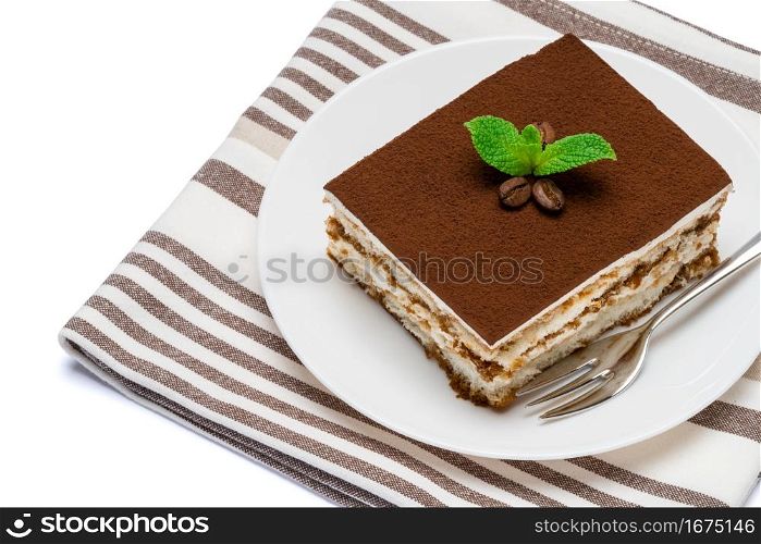 Traditional Italian Tiramisu square dessert portion on ceramic plate isolated on white background with clipping path embedded. Traditional Italian Tiramisu square dessert portion on ceramic plate isolated on white background with clipping path