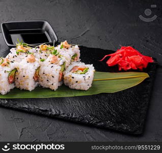 traditional japanese dish rolls with cucumbers and red salmon and onigiri soy sause