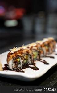 Traditional japanese food cuisine Unagi roll, japanese ell serve with japanese rice and avocado with special sauce.
