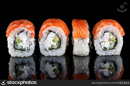 Traditional Japanese Sushi roll Philadelphia. Black background with reflection.. Traditional Japanese sushi roll philadelphia