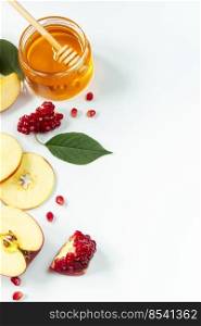 Traditional Jewish holiday New Year. Happy Rosh Hashanah. Apples, pomegranates and honey on a white background. Vertical photo.. Traditional Jewish holiday New Year. Happy Rosh Hashanah. Apples, pomegranates and honey on white background. Vertical photo.