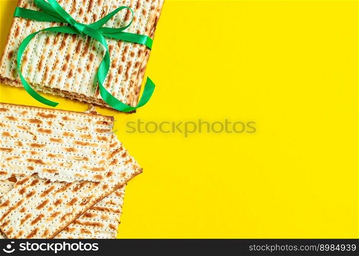 Traditional Jewish matzo on yellow background. Happy Passover. Pesach religious holiday celebration concept. Matzah bread. Copy space.. Traditional Jewish matzo on a yellow background. Happy Passover. Pesach religious holiday celebration concept. Matzah bread. Copy space.