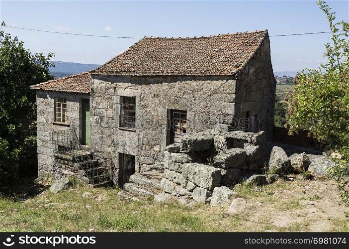 Traditional local granite house of the rural architecture of the Beira Alta region in Portugal