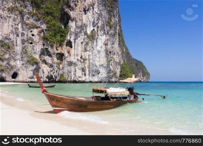 Traditional long tail fishing boat beached on Koh Lao Liang, Trang, Thailand