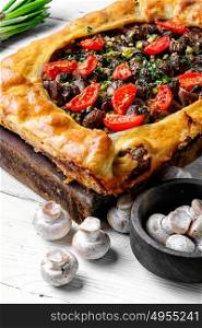 Traditional meat pie. Delicious meat pie stuffed with mushrooms and tomato