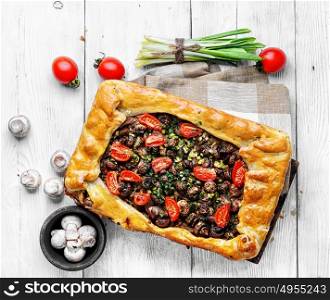 Traditional meat pie. Delicious meat pie stuffed with mushrooms and tomato