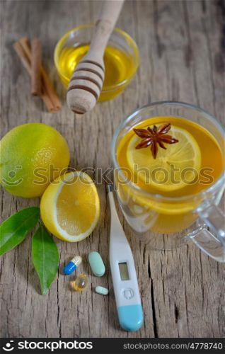 Traditional medicine and flu concept - cup of tea with lemon and honey