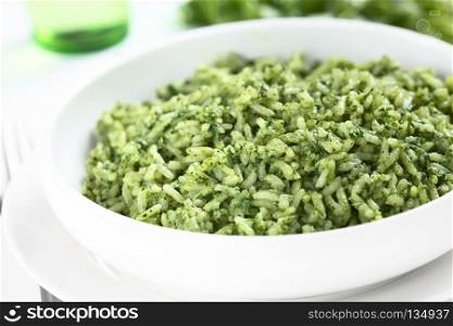 Traditional Mexican Arroz Verde green rice dish made of long-grain rice, spinach, cilantro and garlic (Selective Focus, Focus one third into the rice). Mexican Arroz Verde Green Rice Dish