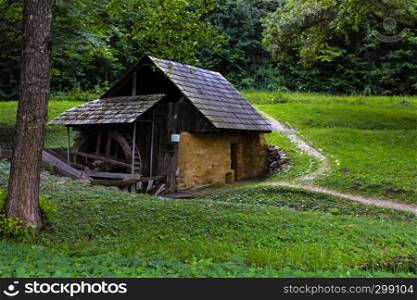 Traditional mill house in the forest woods