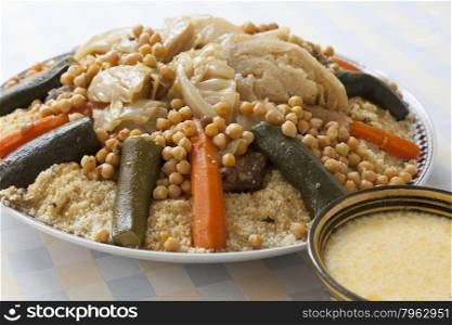 Traditional Moroccan couscous with buttermilk sauce in a bowl