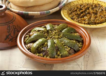 Traditional Moroccan dish with lamb, peas and courgette close up