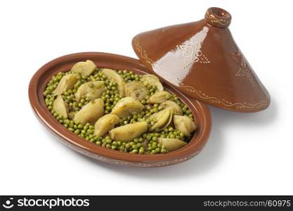 Traditional Moroccan oval tagine with meat, peas and fennel on white background