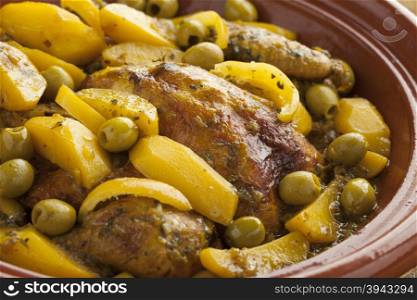 Traditional moroccan tajine with chicken,potatoes and olives close up