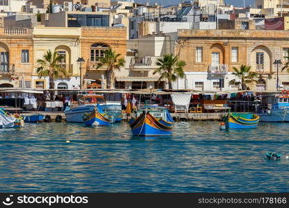 Traditional multicolored fishing boats Luzzi in the harbor Marsaxlokk. Malta.. Malta. Marsaxlokk. Traditional fishing boats.