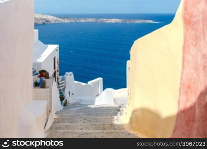 Traditional narrow street down to the sea on the island of Santorini, Greece.