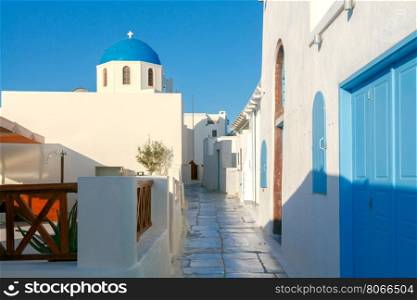 Traditional narrow street down to the sea on the island of Santorini, Greece.