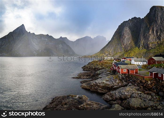 Traditional Norwegian Fishing village, rorbuer, with Lilandstinden mountain, Hamnoy island, Reine, Lofoten, Northern Norway