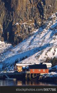 traditional norwegian wooden house rorbu to stand on the shore of the fjord. Lofoten Islands. Norway. world travel
