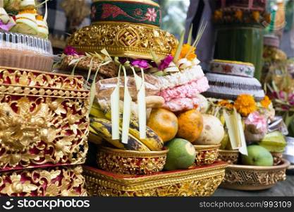 Traditional offerings to gods in Indonesia with flowers, fruits and aromatic sticks in temple, buddhist Bali. Traditional offerings to gods in Indonesia with flowers, fruits and aromatic sticks in temple, buddhist