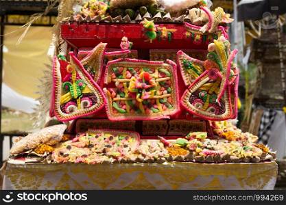 Traditional offerings to gods in Indonesia with flowers, fruits and aromatic sticks in temple, buddhist Bali. Traditional offerings to gods in Indonesia with flowers, fruits and aromatic sticks in temple, buddhist